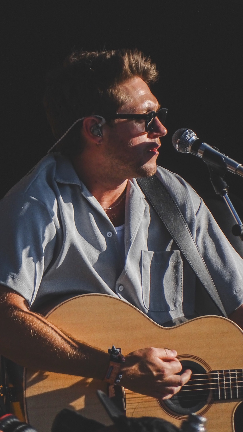 Niall Horan performing live with a guitar